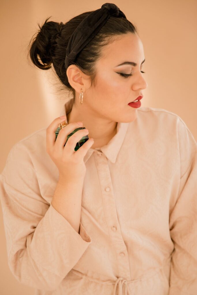Woman applying perfume